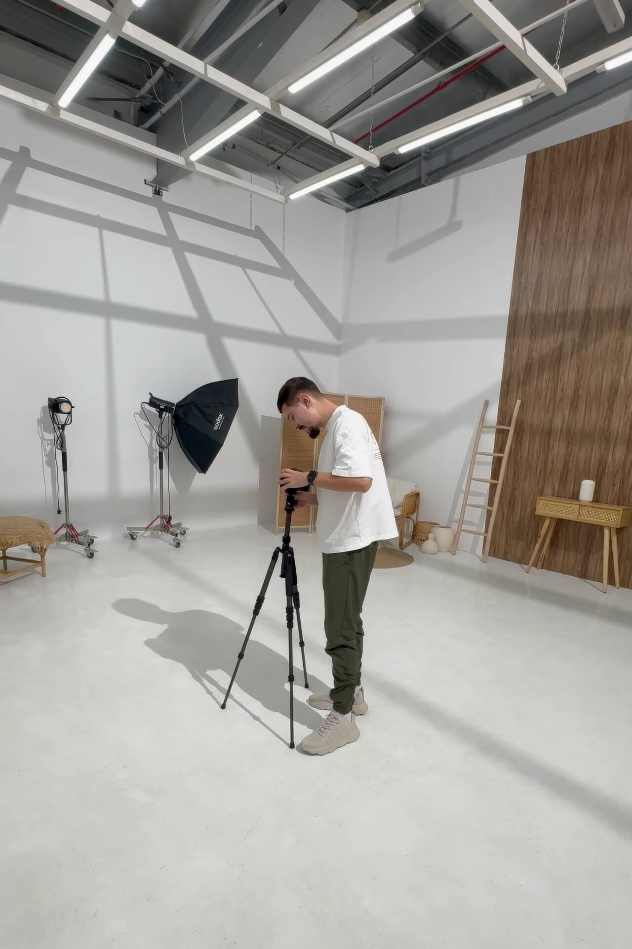 Alex Paiu in studio mounting camera on tripod