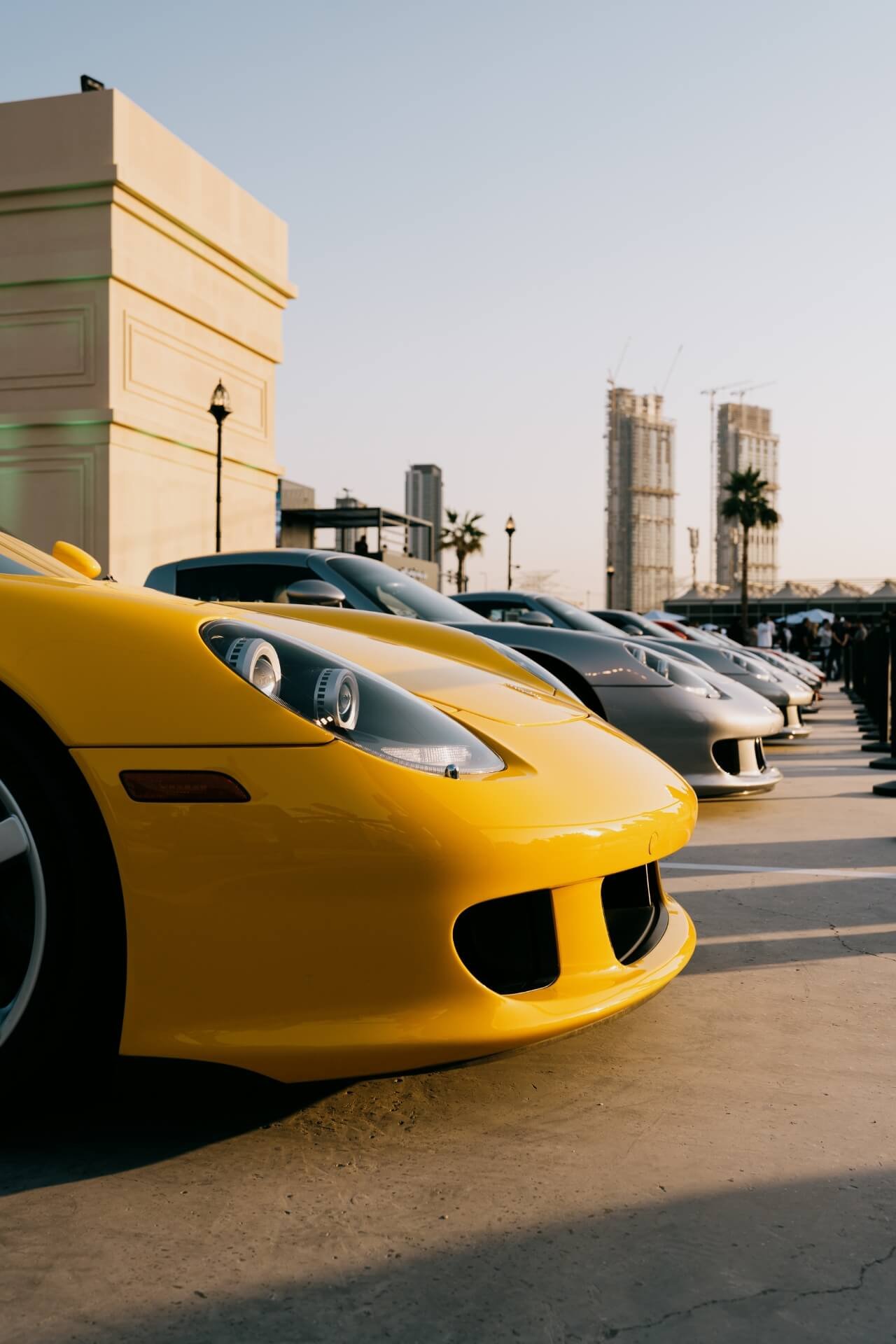 Row full of Porsche Carrera GT with sunset shining on them