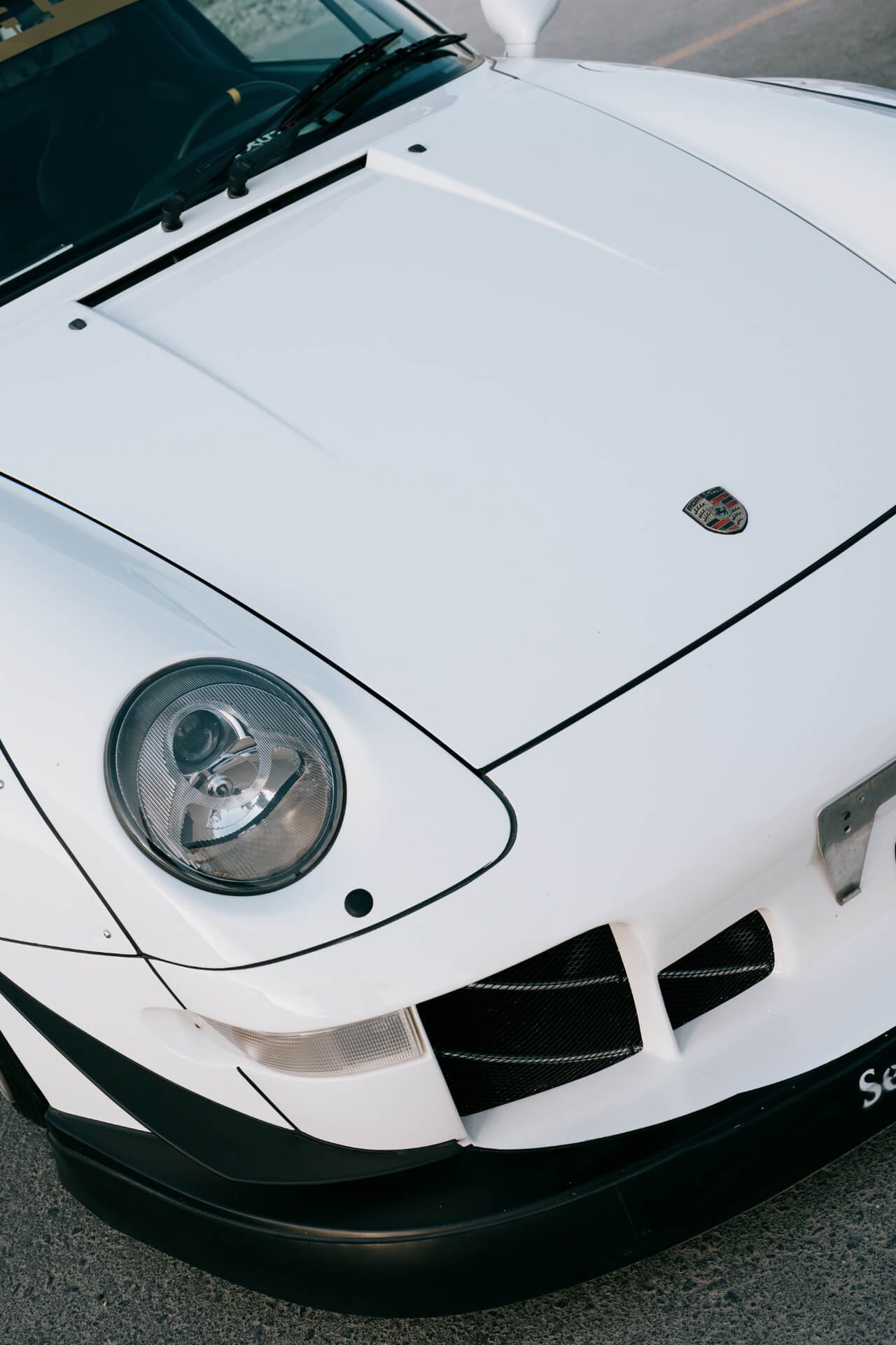 Hood of a white custom tuned Porsche
