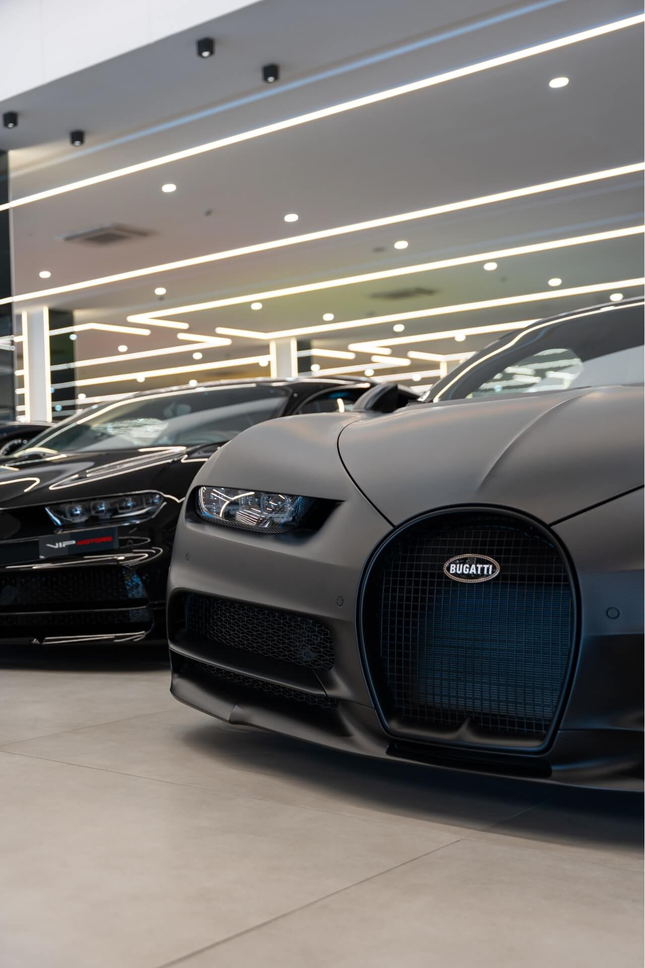 Bugatti Chiron black matte next to another Chiron