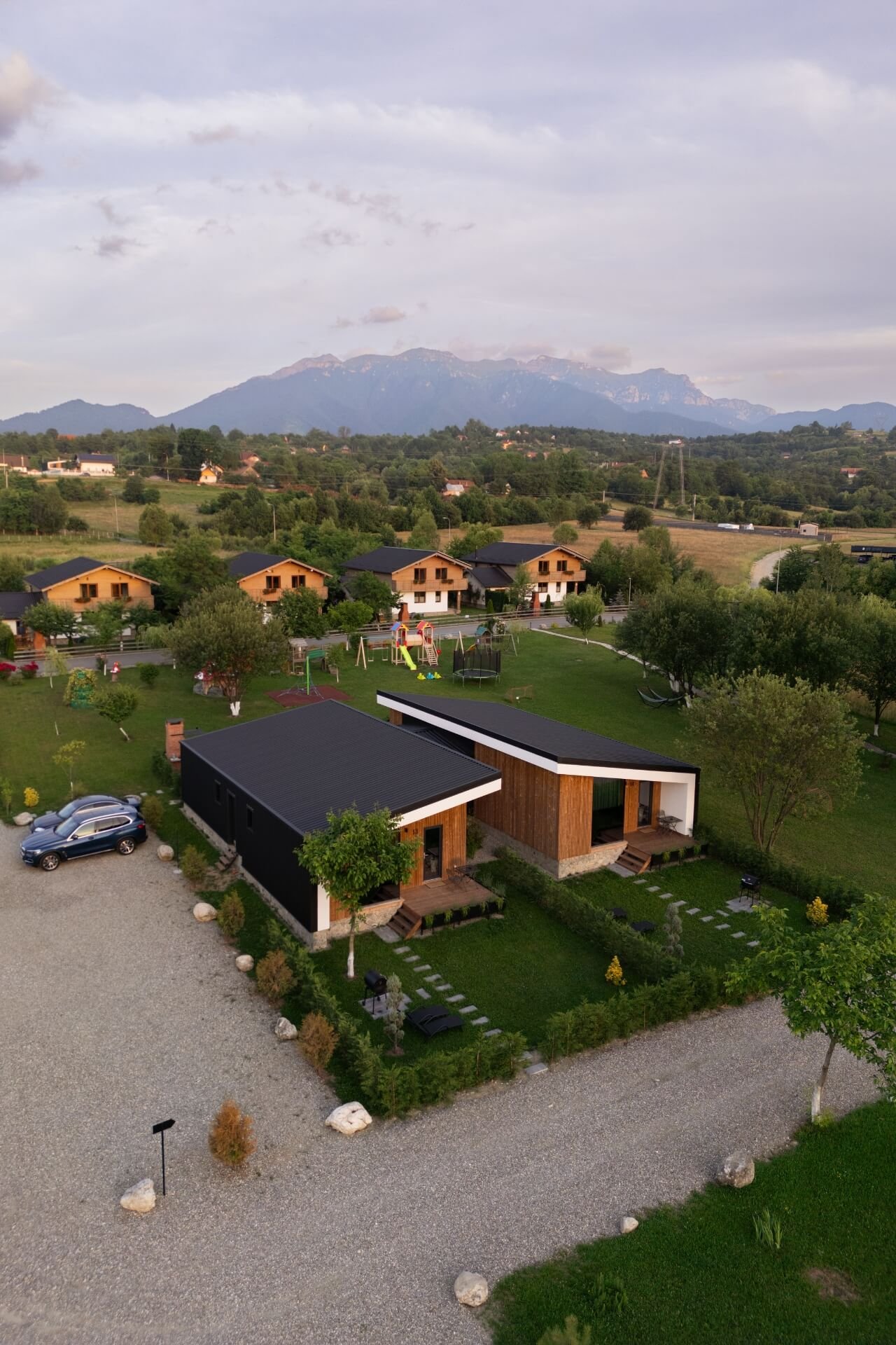 Drone shot of Green Resort Bran with Carpathian Mountains in the back