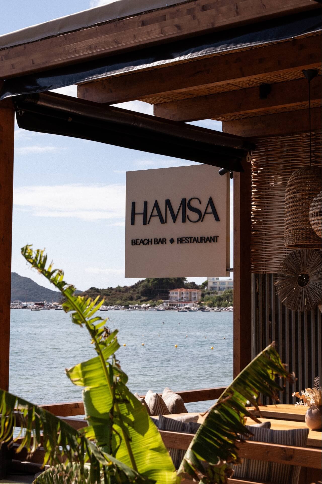 Restaurant area with Hamsa logo and sea view