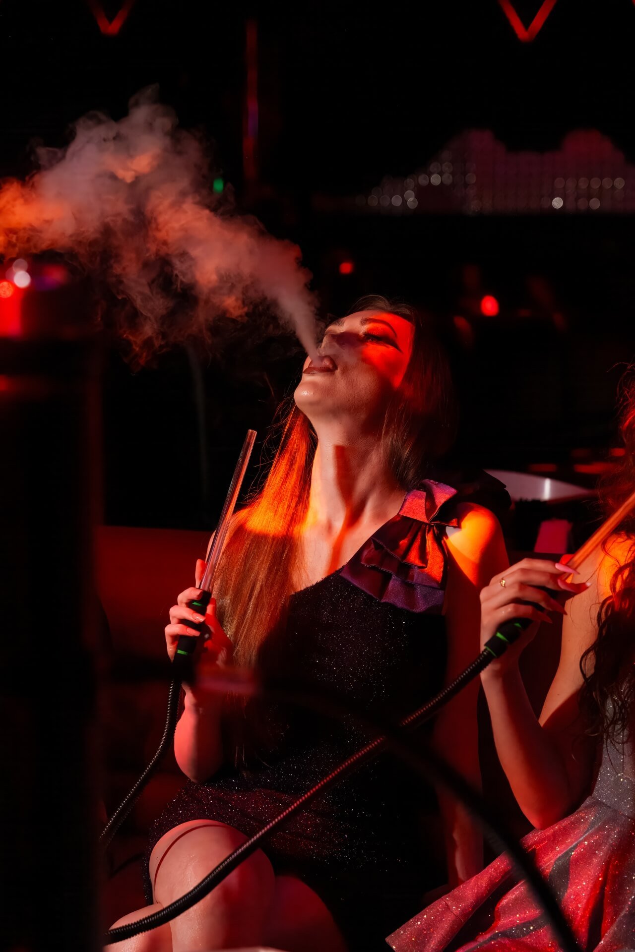 Girl puffing from shisha at Epik Club Dubai