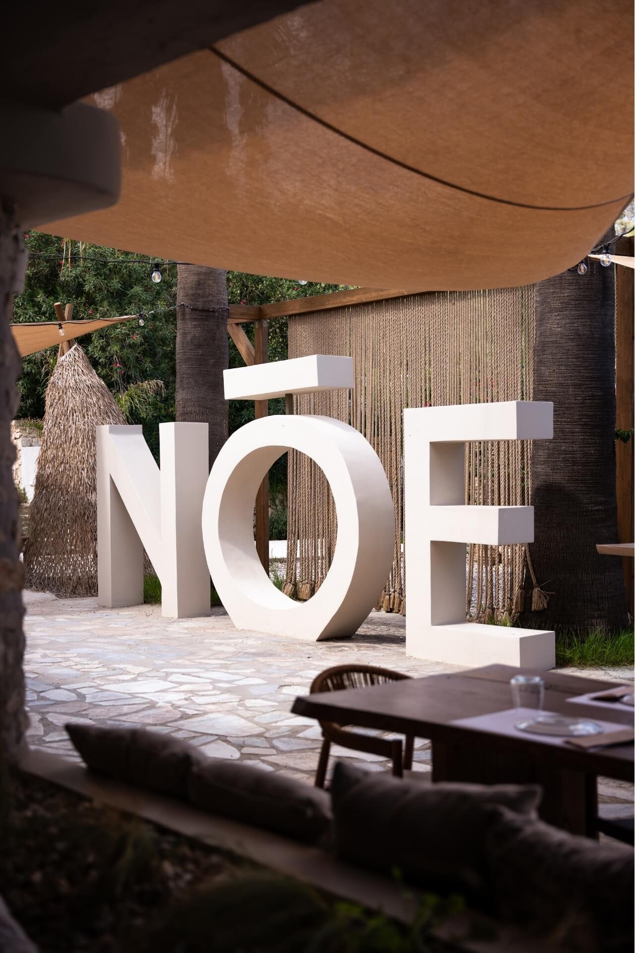 Noe logo at the entrance of the beach with dine area