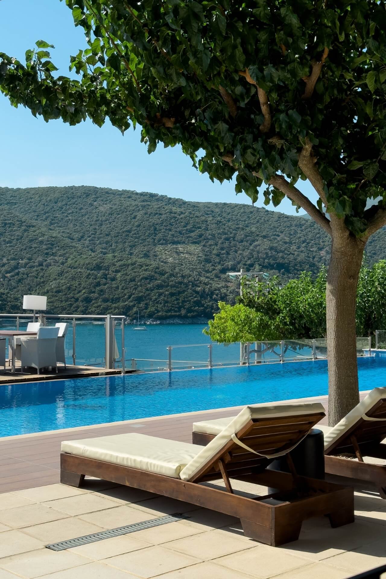 Luxury swimming pool at San Nicolas Lefkada with the sea and hills in the back