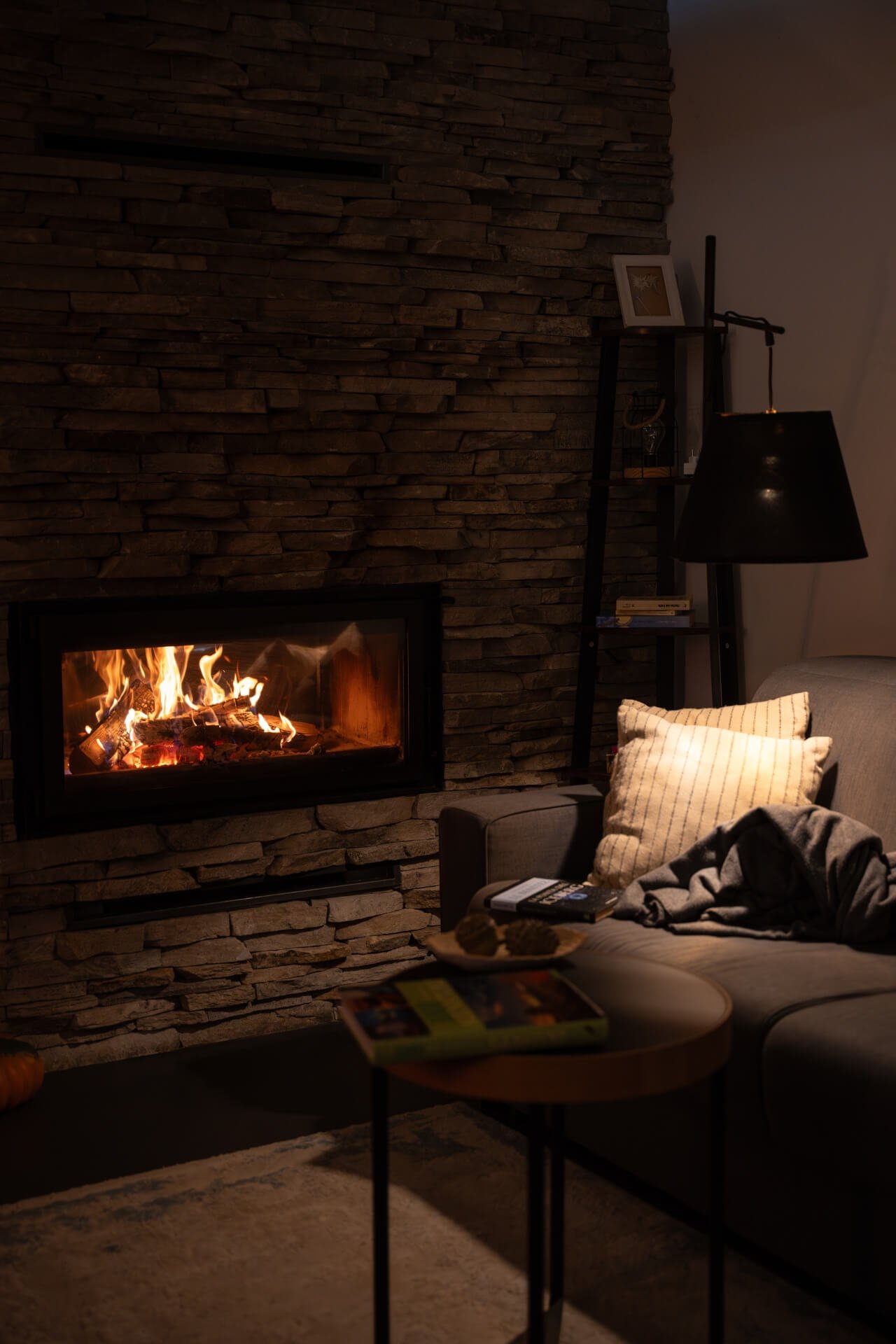 Fireplace inside living room of luxury villa with warm lights on