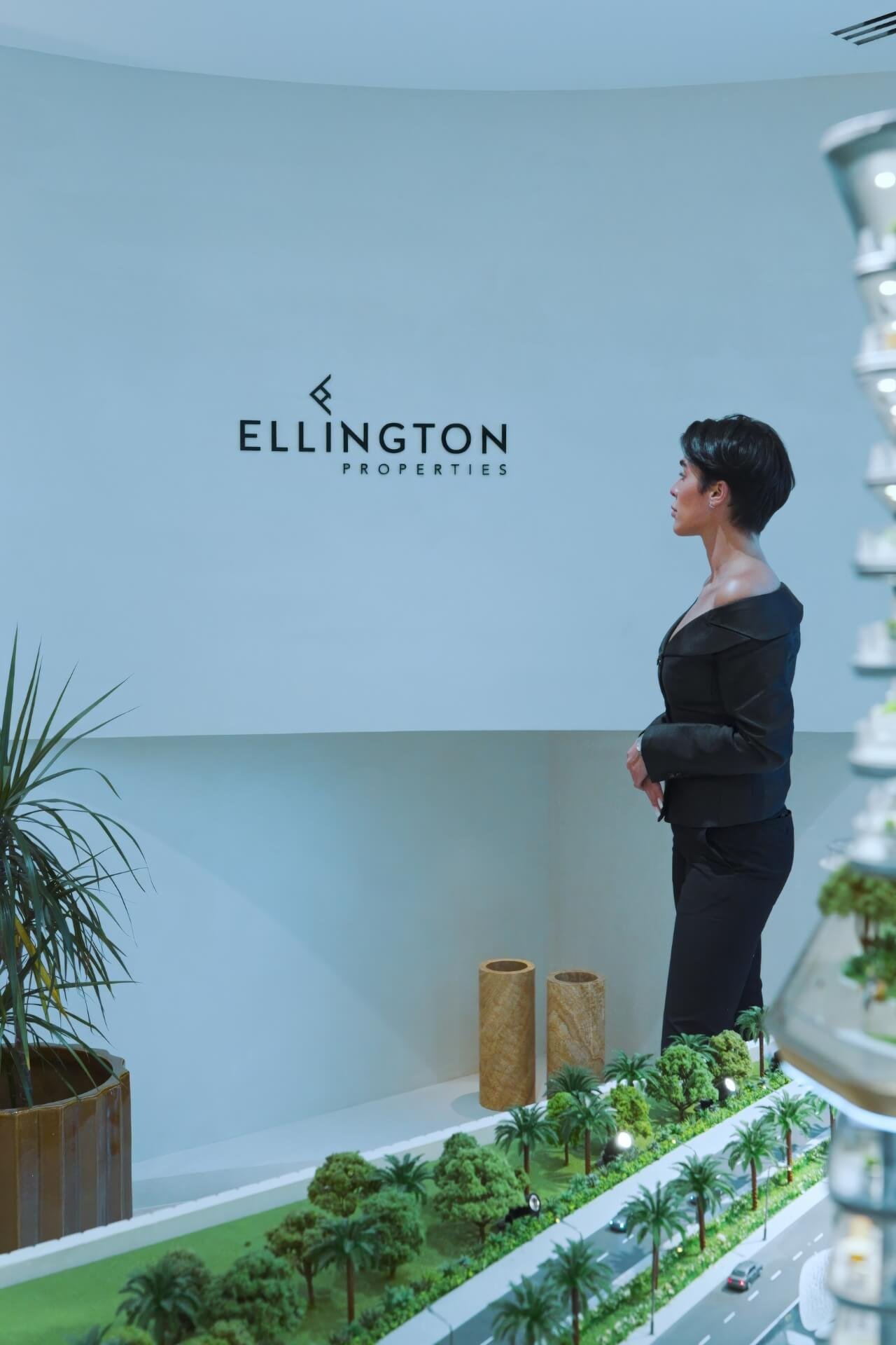 Real estate agent at Ellington showroom with the Ellington Properties logo