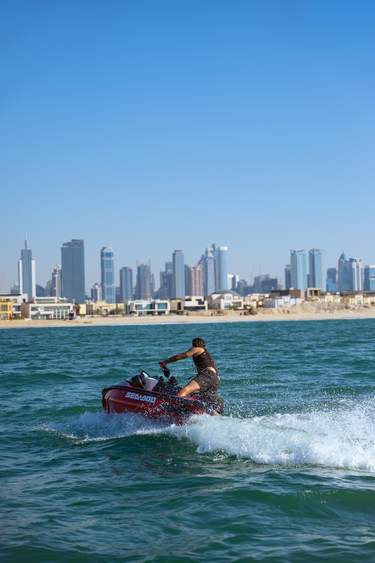 Man on jetski with Dubai skyline in the back