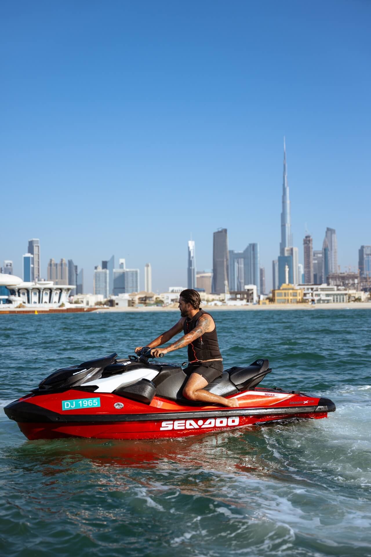 Man on a powerful red jetski admiring Dubai